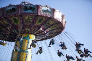 Photo of fair visitors on a large swing ride at the Alameda County Fair in Pleasanton, CA.