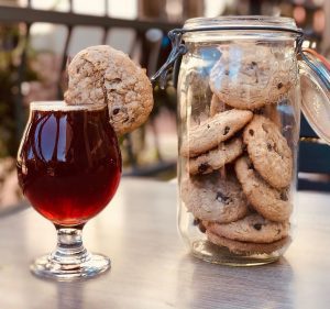 spiced beer with oatmeal cookie on the rim and a jar of cookies