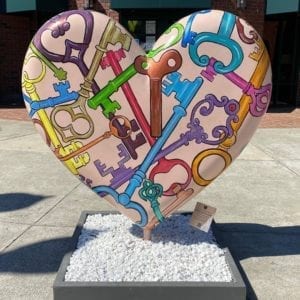 public art installation of large heart painted with keys