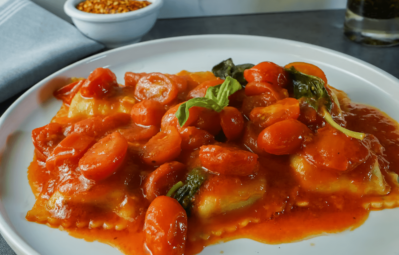 image of ravioli with tomatoes and tomato sauce on place