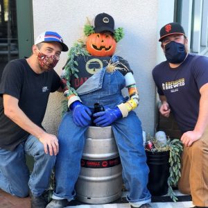 danville brewing employees post with scarecrow