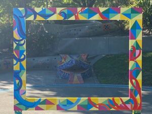 Picture This: Created by a local artist, large colorful frame to take photos in on display in a public park.