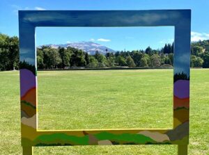 Picture This: Created by a local artist, large colorful frame to take photos in on display in a public park.