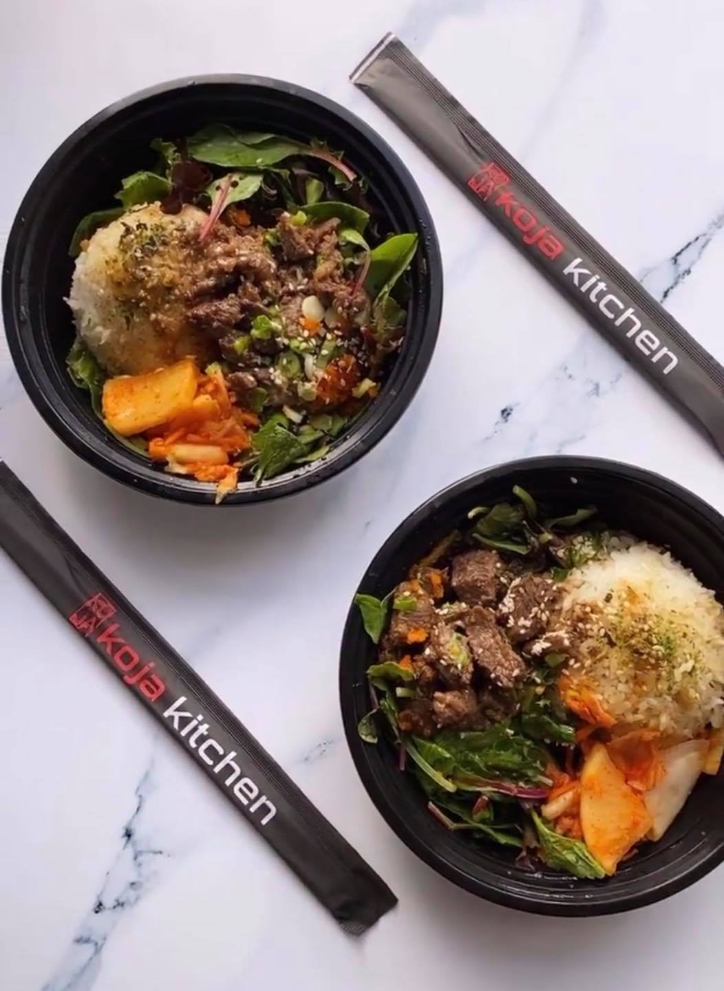 Korean-Japanese fusion meal of two rice bowls and chopsticks from Koja Kitchen.