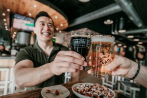 two men cheers beers at danville brewing company